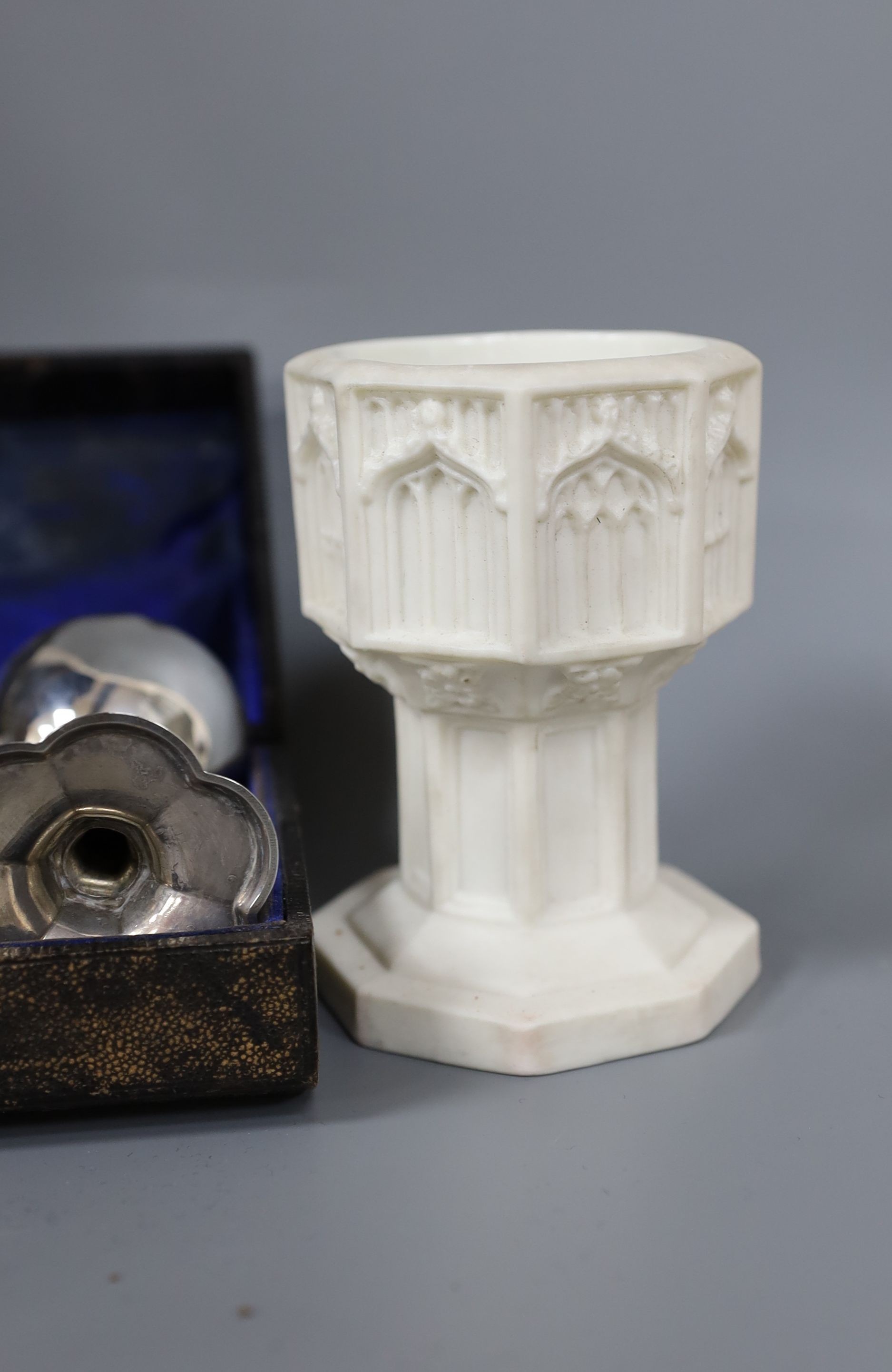 A Victorian Parian baptismal font, 11cm, and a Victorian silver travelling communion set, both cased